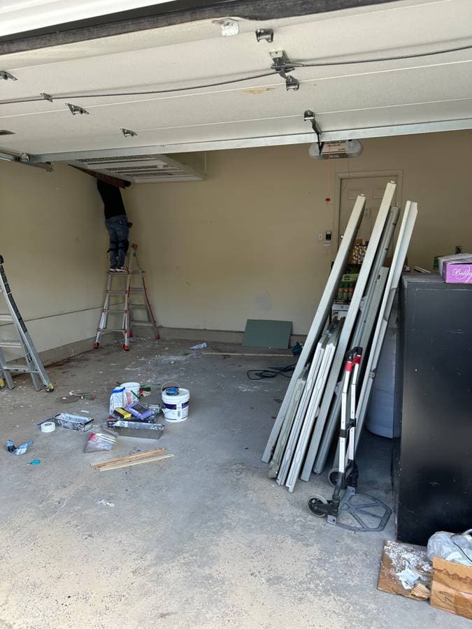 picture of a garage in long island new york being remodeled with new paint and garage doors