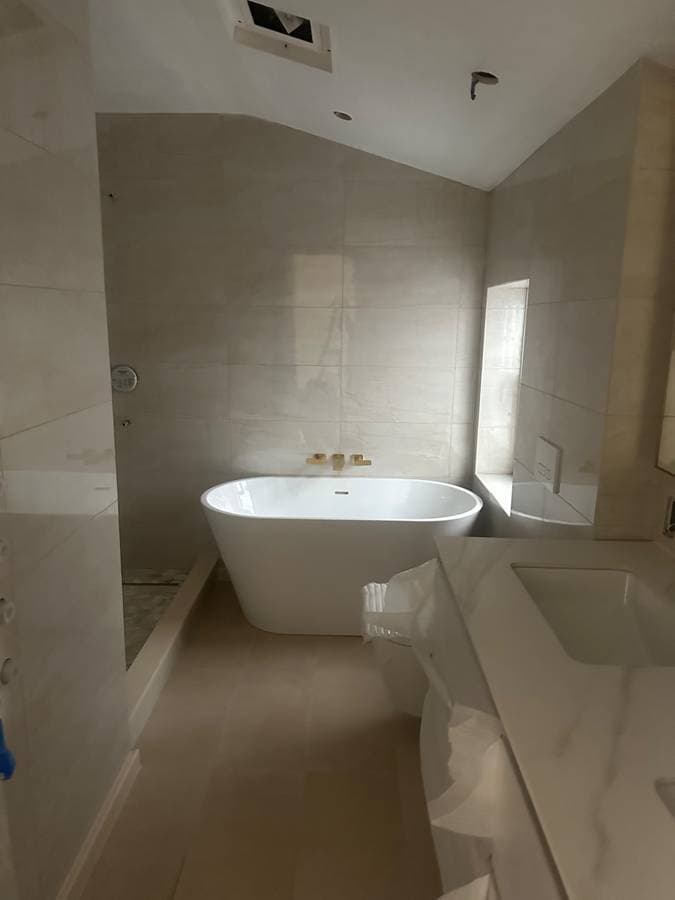 picture of a new york city residential home bathroom remodel with luxury bathtub and tile
